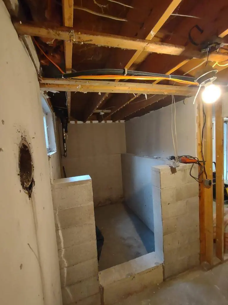 Cinderblock buried inside an interior basement partition wall, uncovered during demolition
