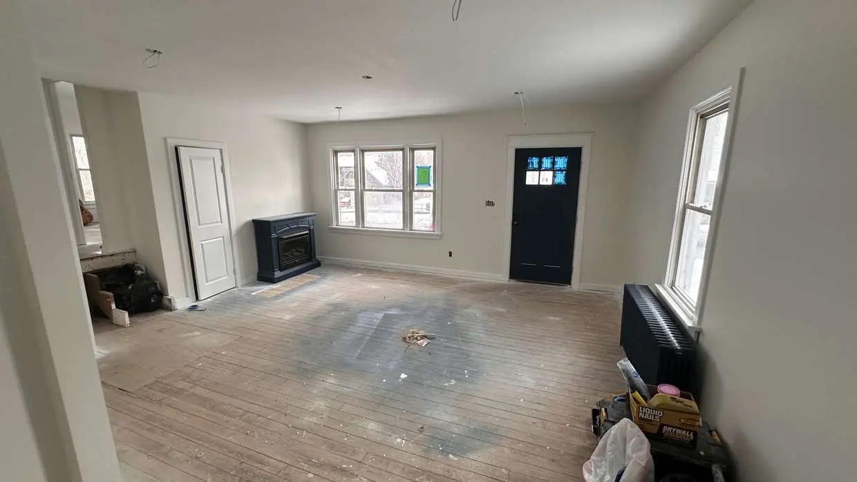 Living room after drywall and primer, before flooring and trim