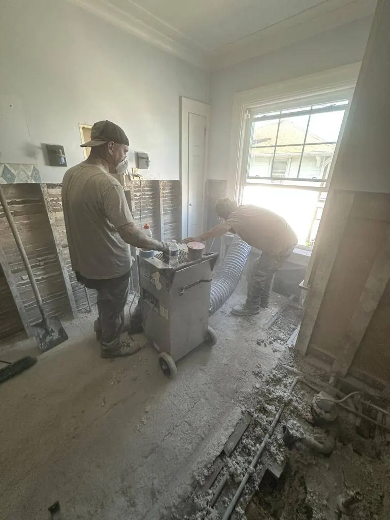 HEPA air scrubber running during demolition with its duct out the window, and the room sealed off from the rest of the house