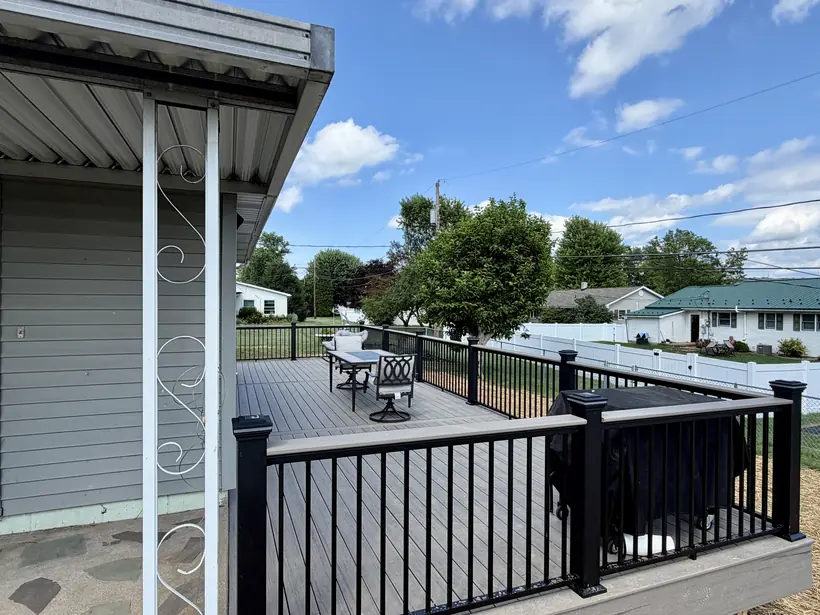 Finished deck looking out across the railing from the covered porch