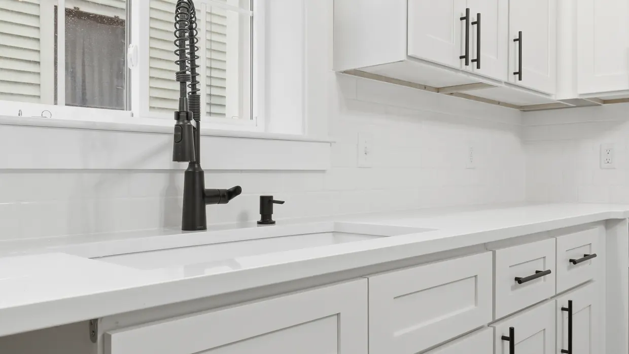 Kitchen remodel in Central Pennsylvania with white shaker cabinets, quartz counters, a subway tile backsplash and matte black fixtures, by Smego Construction