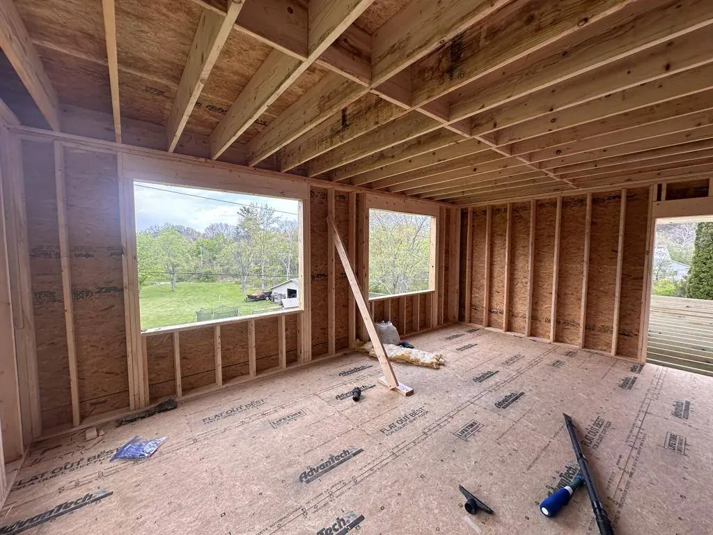 Interior framing of the addition with window openings and the floor sheathed