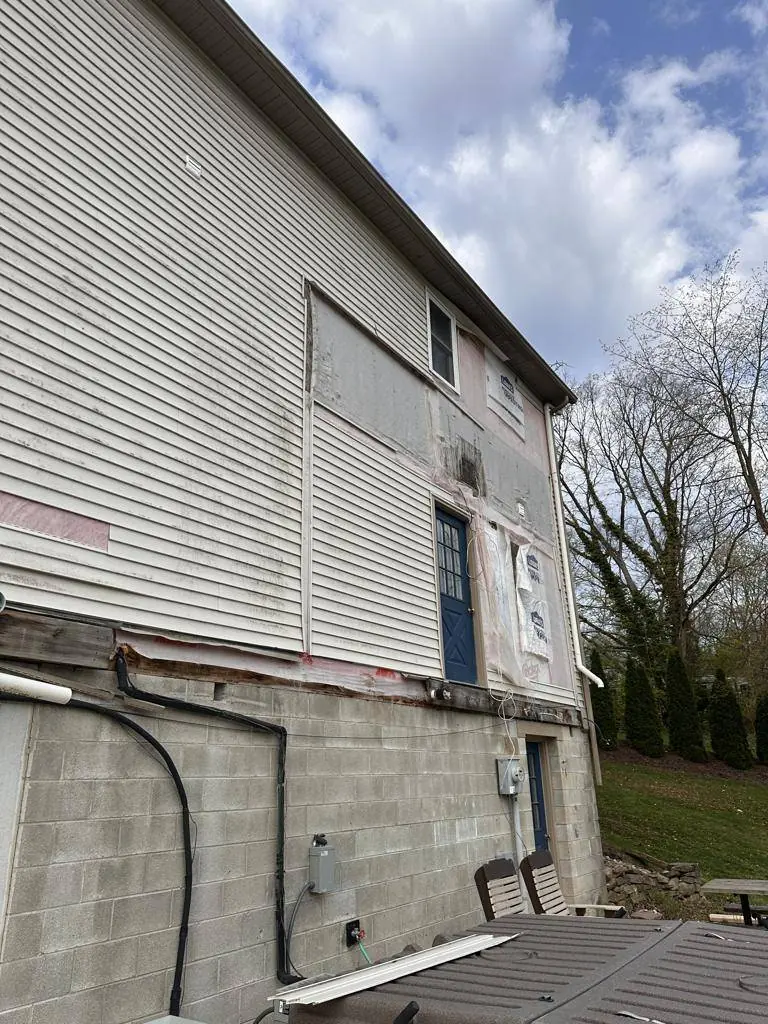The existing block foundation wall and retaining wall on the downhill side of the house before the addition went up