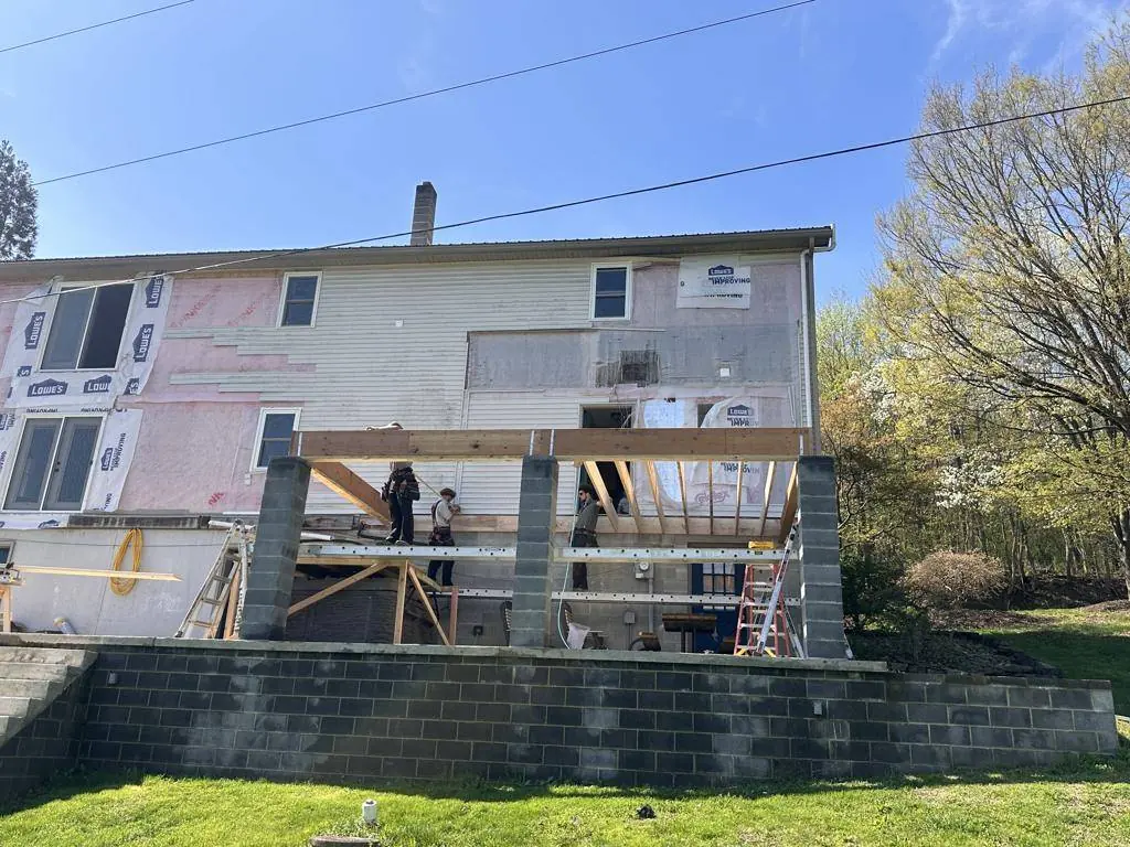 LVL beams set across the masonry piers to carry the addition's floor framing