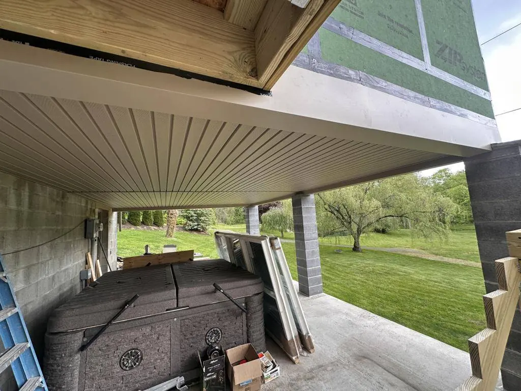 Finished soffit seen from below, running level with the soffit on the existing house