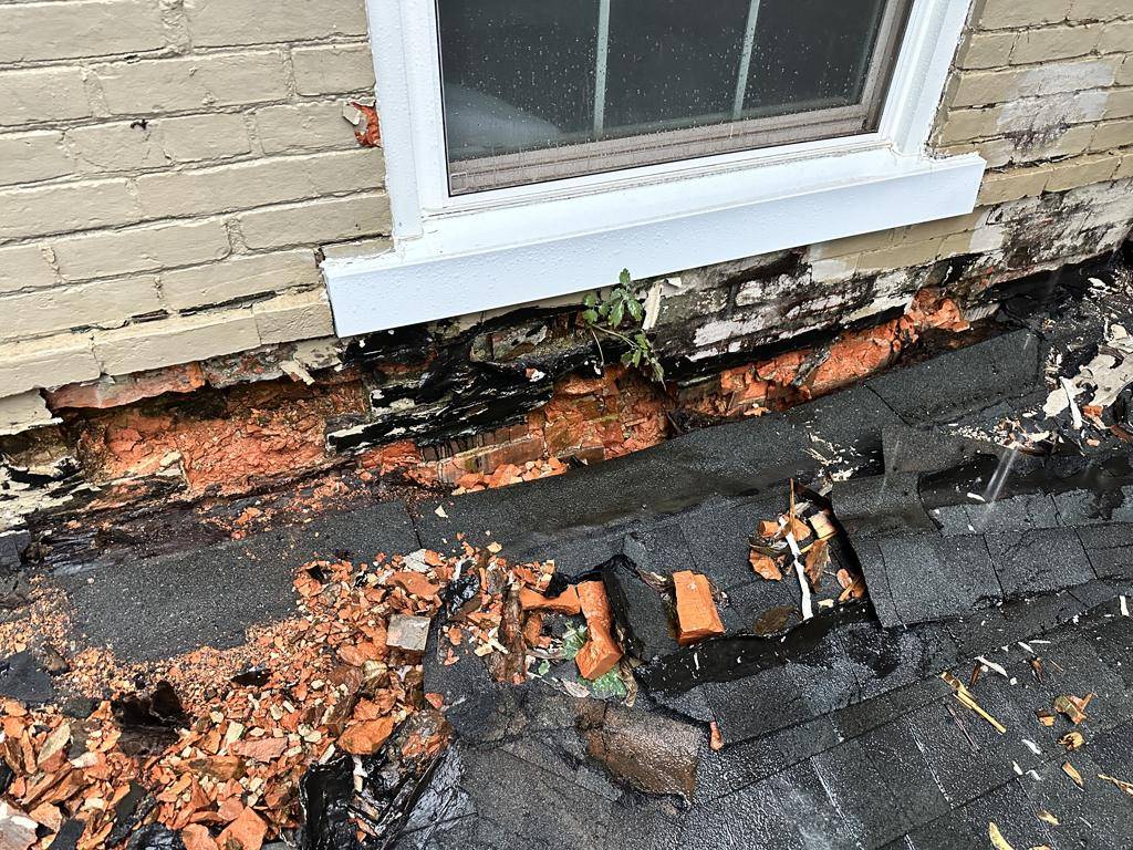 Rotted roof framing uncovered over a porch — the only change order on the six-month project