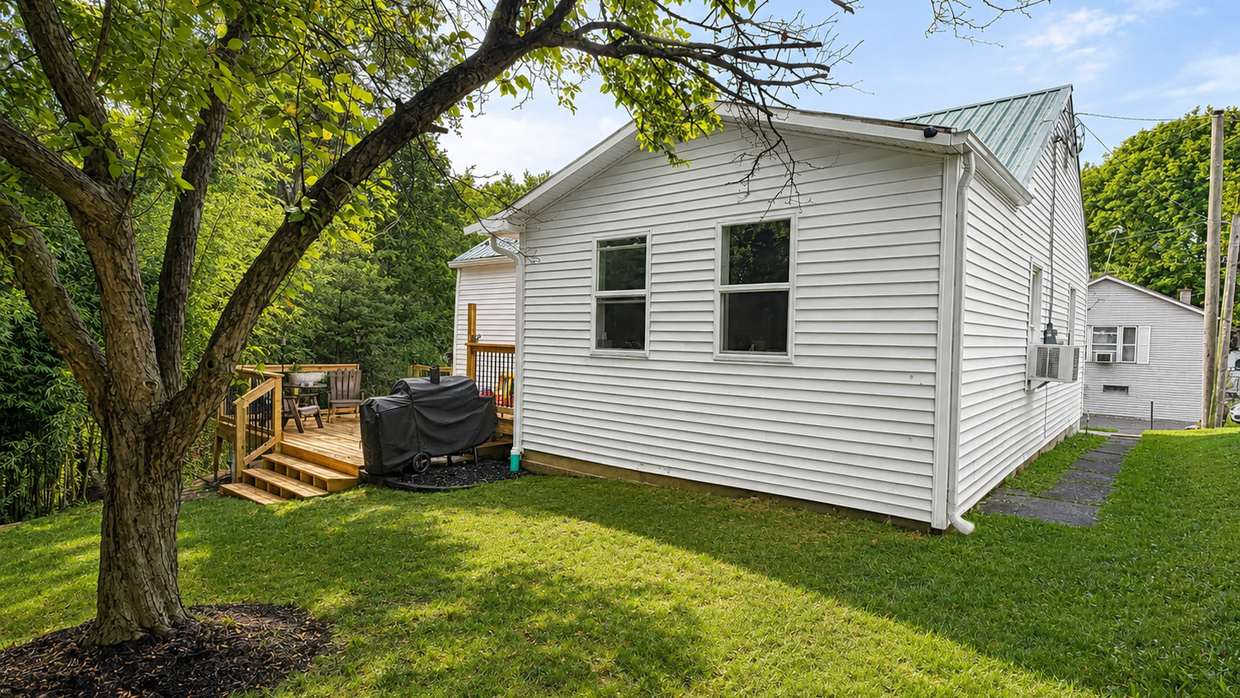 Finished rear yard, deck and exterior after the bamboo was cleared and the lot regraded