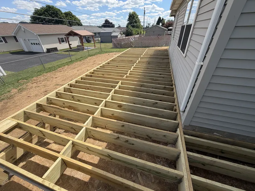 Deck framing at the ledger where the structure meets the house