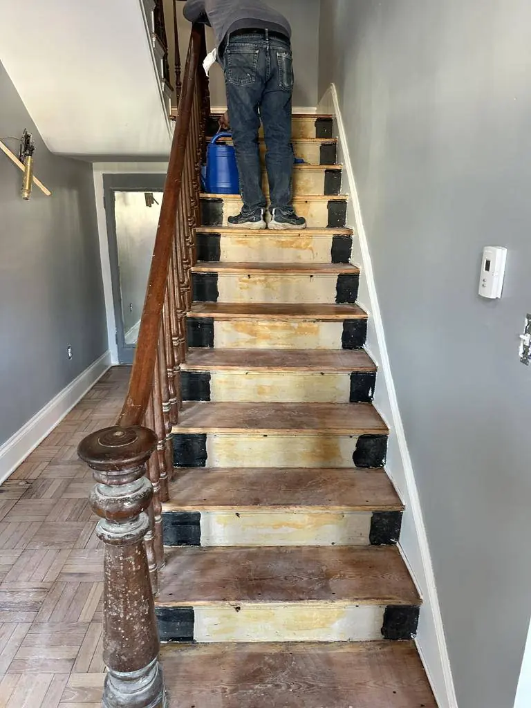 Original staircase and handrail boarded over and protected while construction went on around it