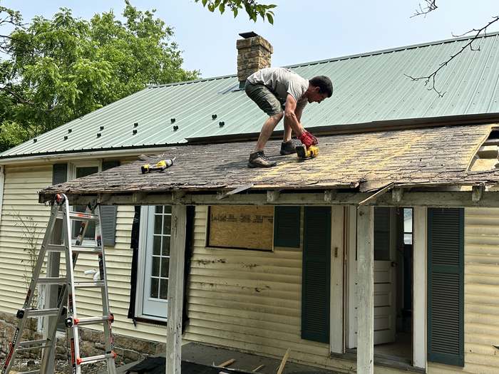 Mike Smego on the roof removing the original rear porch