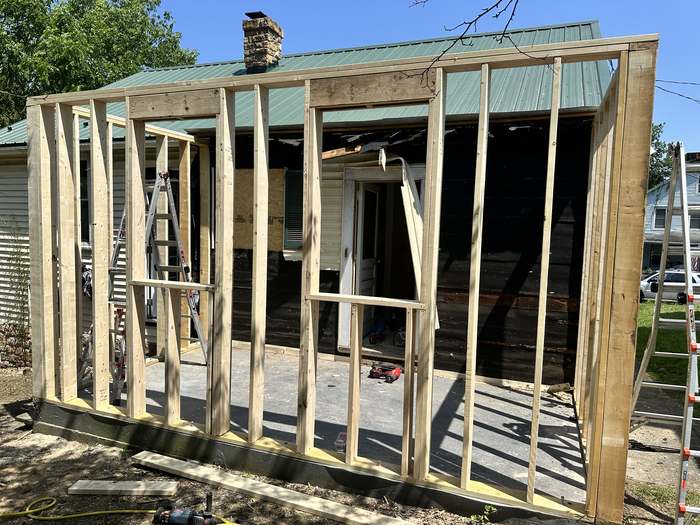 Rear addition framed open to the existing house, adding a third bedroom